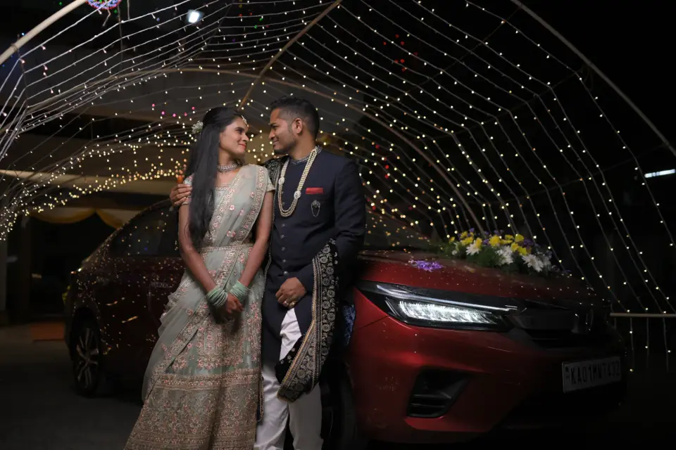 Couple at their wedding reception entrance under a canopy of fairy lights